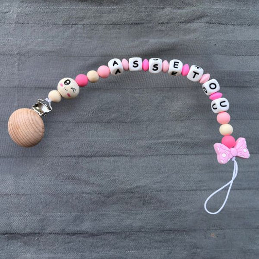 Attache tétine noeud rose